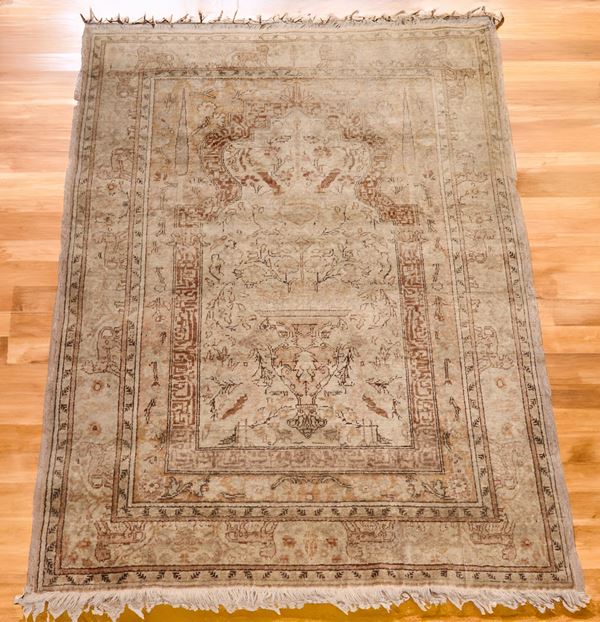 Ghiordes prayer rug, with floral designs on a brown background. Defects