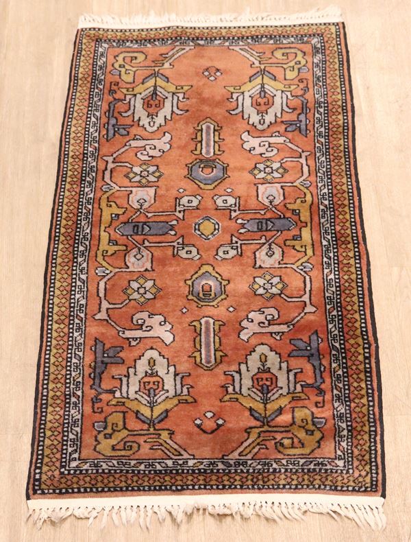 Kazak carpet with geometric patterns on antique pink and white background