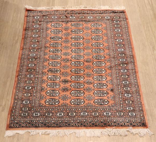 Bukhara carpet with geometric designs on orange and white background