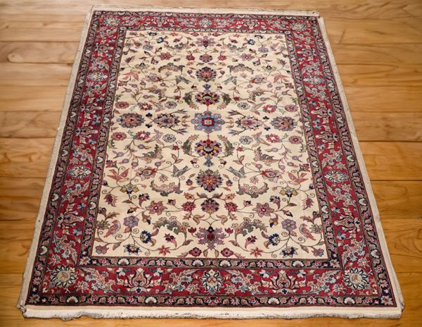 Persian Mashad carpet with floral designs, on a red and brown background