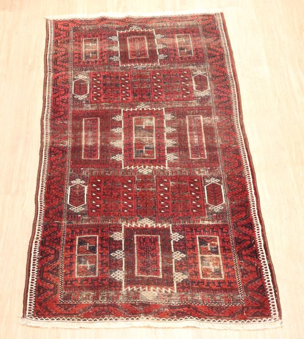 Turkaman carpet with geometric designs on red and white background