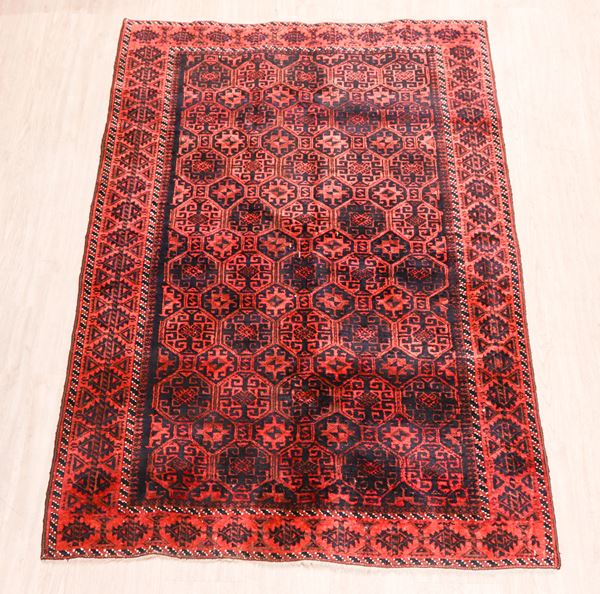 Baluch Persian carpet with geometric designs on red background