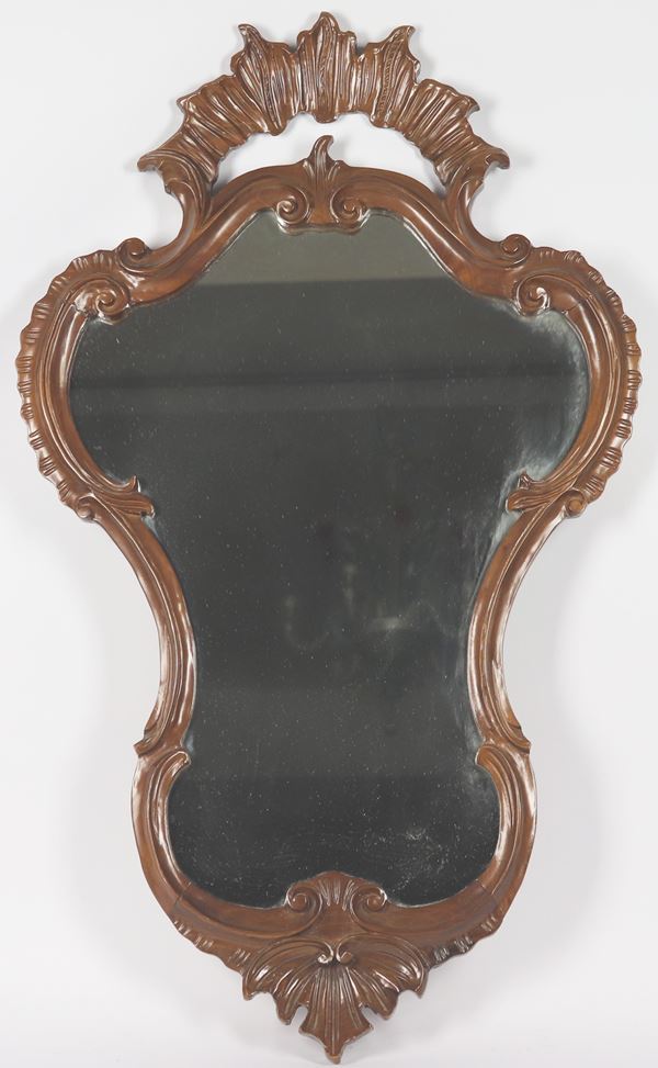 Walnut-colored wooden arched mirror with carved friezes