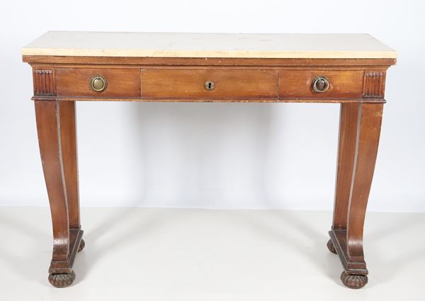 Empire style console table in walnut with three drawers, four legs, two of which are curved, and a light marble top, the undertop has 2 holes