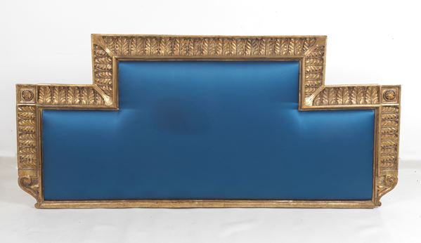 Antique Empire headboard in gilded wood and carved with palmettes and rosettes covered in blue Chinese satin