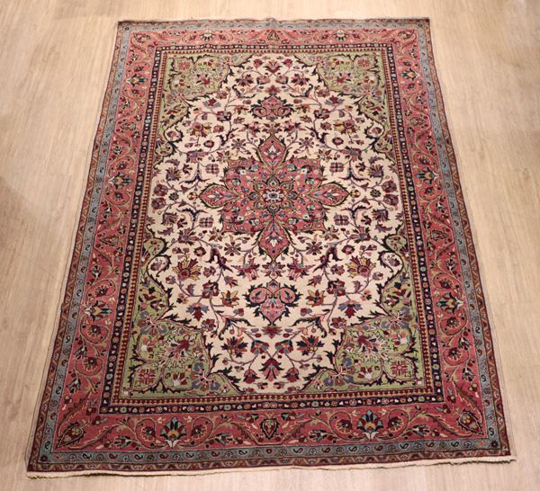 Islamabad Persian rug with geometric and floral design on a brown and green background