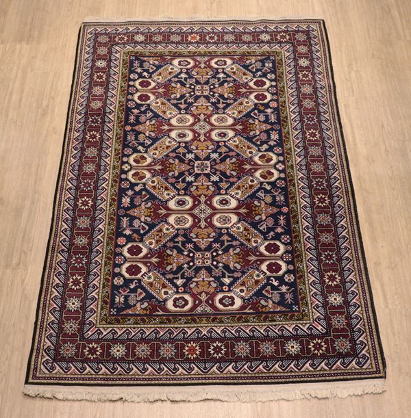 Persian Kazak rug with geometric and floral design on blue and Havana background