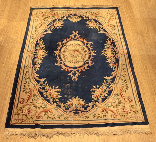 Oriental rug with floral design on cobalt blue background, rapè