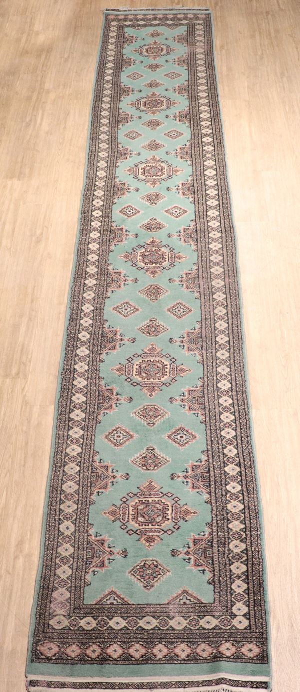 Persian rug with geometric designs on a light green and brown background