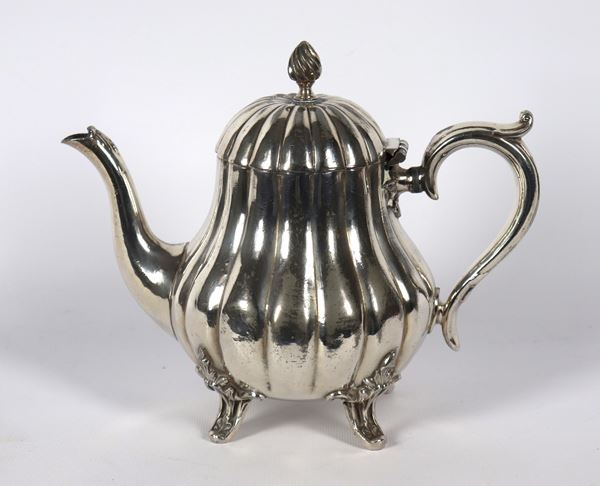 Antique coffee pot in silver-plated metal with pods, supported by four curved feet