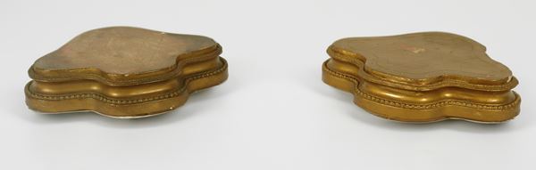 Pair of antique small gilded and carved wooden bases with an arched shape