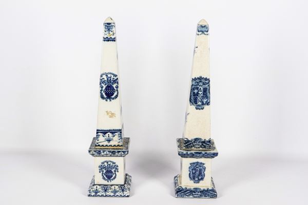 Pair of white porcelain obelisks with cobalt blue floral decorations