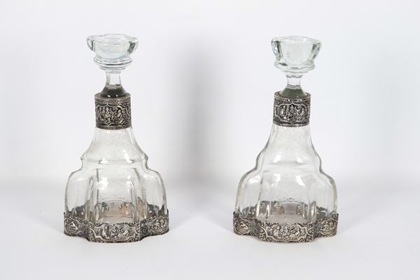 Pair of antique French bottles in glass embossed with floral motifs, with necks and bases in chiseled and embossed silver with scenes of Chinese life