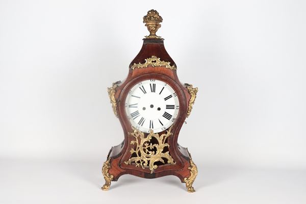 Antique Roman pendulum clock case in rosewood and purple ebony with friezes and applications in gilded bronze, embossed and chiseled, white enamel dial and Roman numerals. The pendulum clock is completely missing its mechanism. 