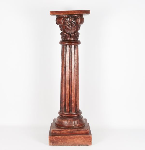 Small carved wooden column with fluted capital and shaft