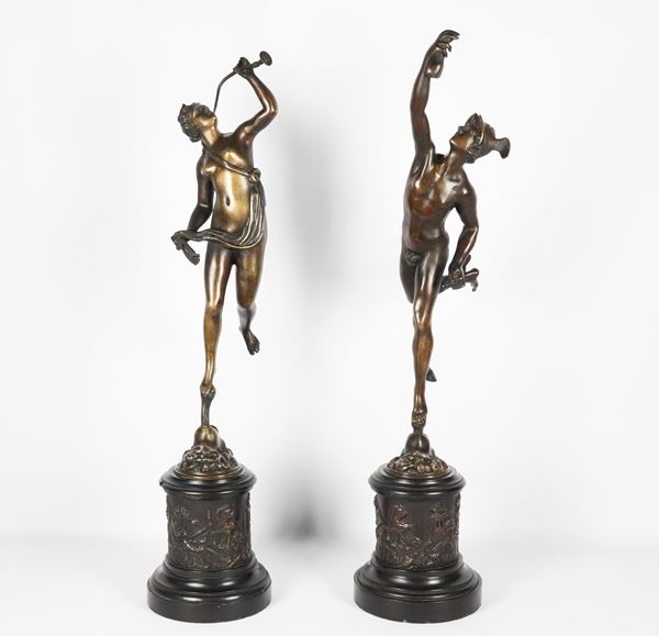  &quot;Mercury and Vestal with trumpet&quot;, pair of ancient French sculptures in chiseled and embossed bronze, supported by column bases in black Belgian marble, covered in bas-relief with &quot;Allegories of putti&quot;