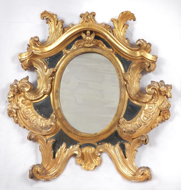 Antique mirror in gilded wood and carved with Louis XIV motifs