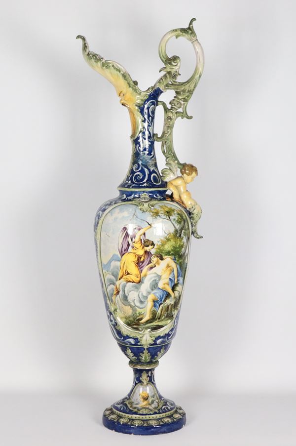 Large ancient amphora in Italian glazed majolica, decorated with mythological scenes. The amphora has two breaks glued back to the neck and handle