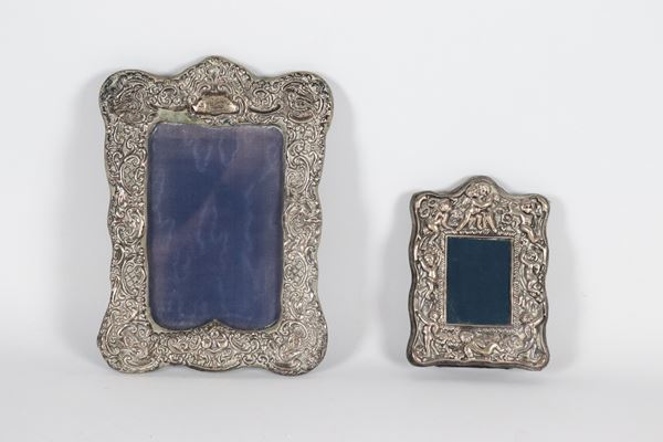 Lot of two antique English silver picture frames, the large one chased and embossed with floral scrolls, the small one with motifs of cheering putti. Chester stamps, Edward VII period