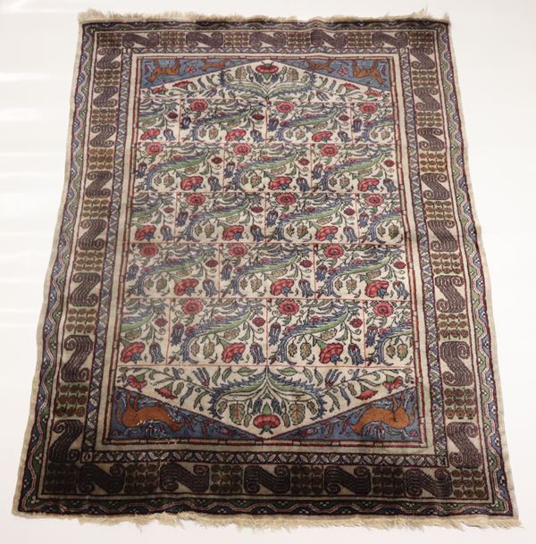 Persian rug with floral design on a brown and green background