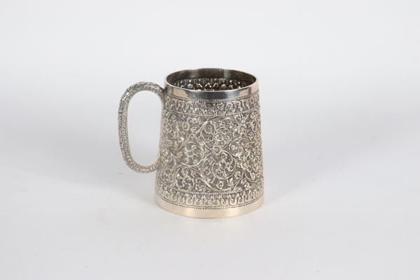 Small oriental silver jug, entirely chiseled and embossed with floral interlacing motifs, 180 gr.