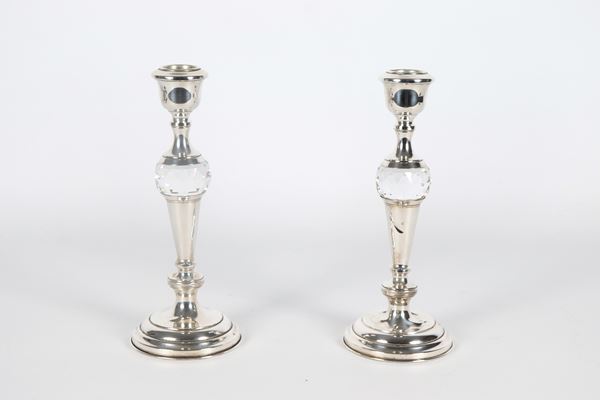 Pair of candlesticks in chiseled and embossed silver and worked crystal