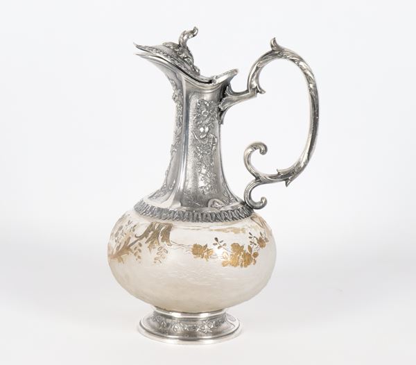 Jug in decorated crystal and silvered metal, embossed and chiselled with Louis XVI motifs 