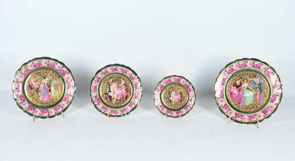 Lot of four Old Vienna porcelain plates, entirely multicoloured with mythological scenes in the centre, various sizes. One plate has a small lack on the edge