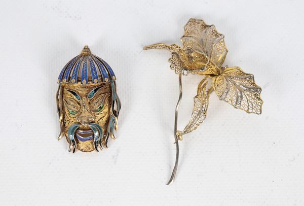 Lot of two filigree silver and enamel pins, one with a leaf and flower motif and one with a Samurai face 