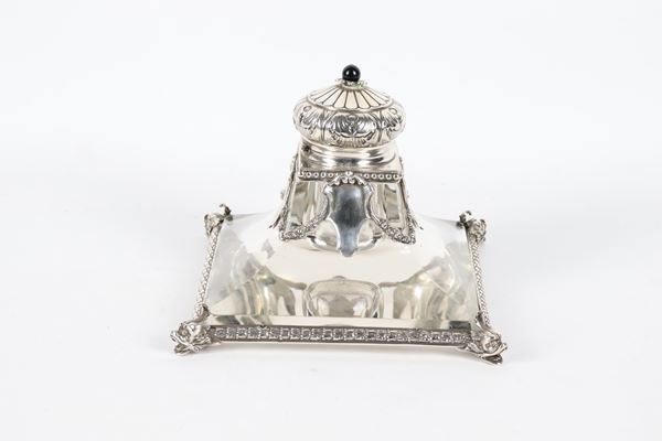 Antique square-shaped silver and crystal inkwell, chiseled and embossed with floral garland and beading motifs, supported by four dolphin heads