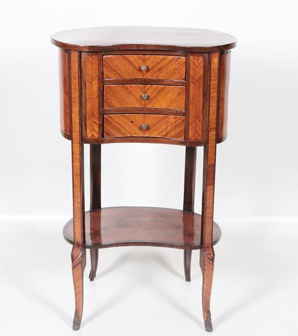 Antico piccolo gueridon francese "a fagiolo", in bois de rose, legno satinato e mogano, tre tiretti, pianetto scorrevole laterale porta candele e quattro gambe ricurve riunite da pianetto intarsiato