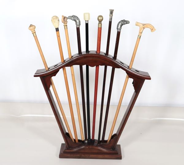 Lot of nine antique walking sticks, with knobs of various shapes and materials, solid mahogany support. The handle of one stick is missing