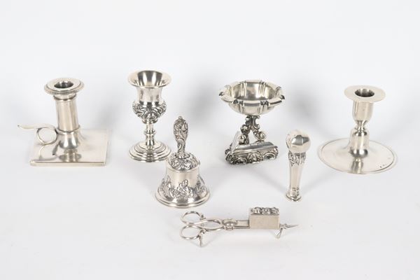 Antique lot in chiseled and embossed silver of a salt shaker, a small chalice, a candle holder, a candlestick, a candle snuffer, a seal and a bell (7 pcs), gr. 590