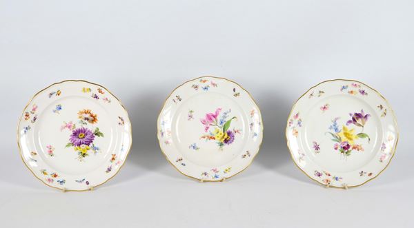 Antique Meissen porcelain lot of three dessert plates, with polychrome decorations with motifs of bunches of flowers, butterflies and insects. 19th century