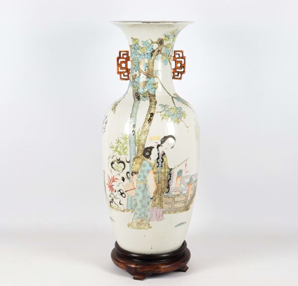 Antique Chinese porcelain vase, Tao Kuang period (1821-1850), entirely decorated with polychrome enamels in relief with motifs of scenes of oriental life, trees, flowers and inscription, fake coral handles