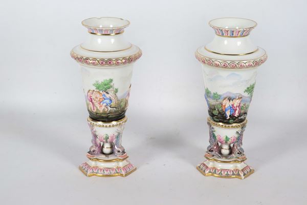 Pair of antique polychrome Capodimonte porcelain vases with mythological figures in relief and dolphin sculptures, defects