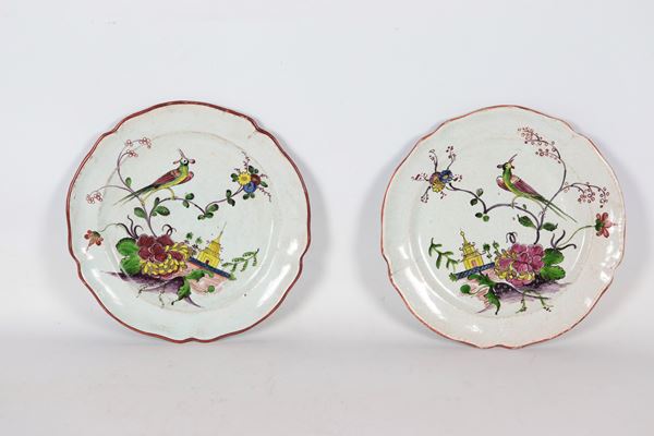 Pair of antique Milanese majolica plates with chinoiserie relief enamel decorations. One plate has a chiseled finish