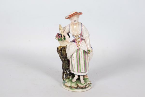 &quot;Peasant Woman with Basket of Roses&quot;, antique polychrome porcelain figurine from Niederwiller, minor defects. 19th Century