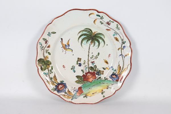 Antique Milanese majolica plate entirely decorated in relief with floral scrolls, palm and parrot