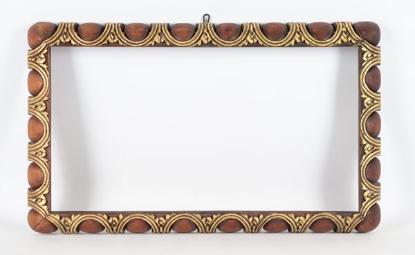 Patinated and gilded wooden frame with pod motifs