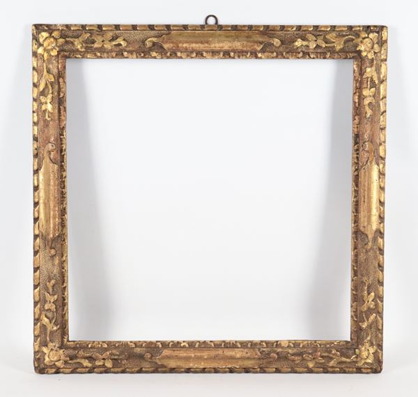 Antique small frame in gilded wood and carved with plant motifs