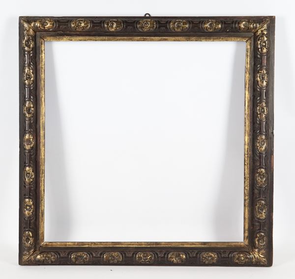 Antique small patinated and carved wooden frame, traces of gilding