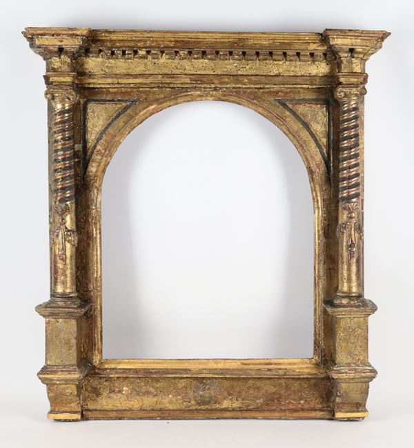 Ancient Tuscan frame in the shape of a temple in gilded and carved wood