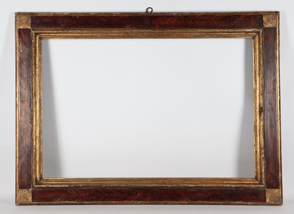 Antique gilded wooden frame decorated with fake wood. Defects on the back of the frame 