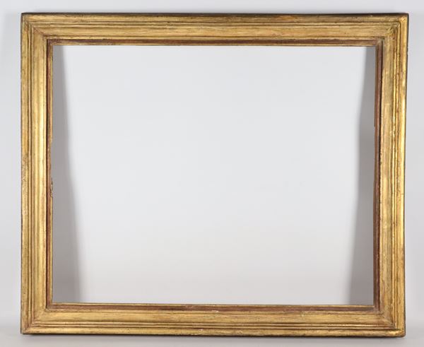 Antique carved wooden frame with traces of gilding