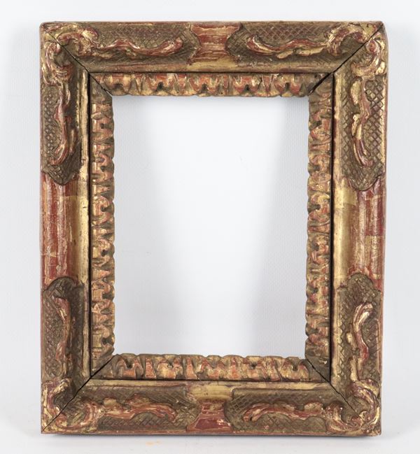 Antique small frame in gilded and carved wood